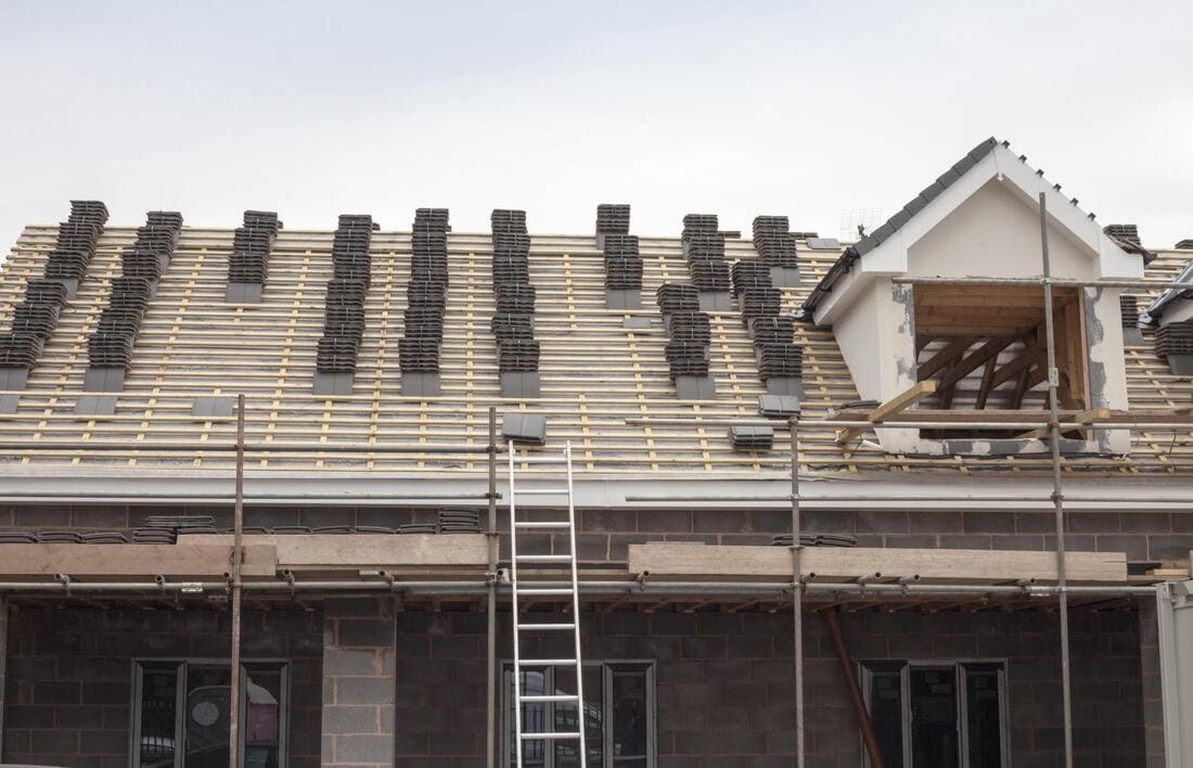 Re-roofing work in progress with scaffolding